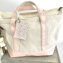 Load image into Gallery viewer, Crossbody Ivory Tote w/ Pink Accent handles and Coquette style Initial Bag Tag with charm