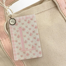Load image into Gallery viewer, Crossbody Ivory Tote w/ Pink Accent handles and Coquette style Initial Bag Tag with charm